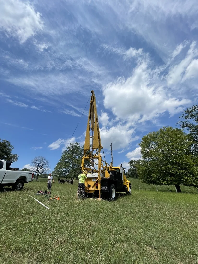 Drilling rig set up in an open field for a new well
